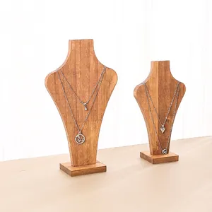 Set of two natural wood bust stands for necklace display featuring star and heart pendants