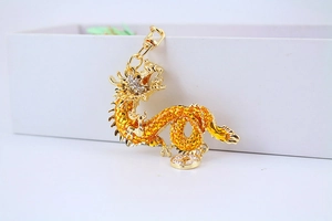 Detailed view of a golden dragon keychain featuring intricate yellow and clear rhinestones