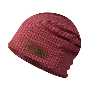 Detail of burgundy ribbed knit beanie featuring a brown leather tag with fishbone metal accent