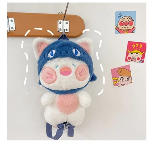 Detailed close-up of a plush cat pendant wearing a blue shark hoodie with hanging cord