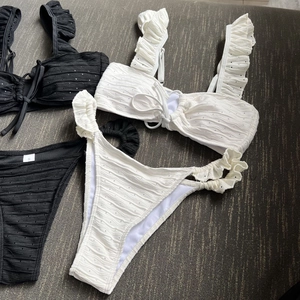 Close-up of bikini sets showing textured ruffled fabric and adjustable drawstring detail