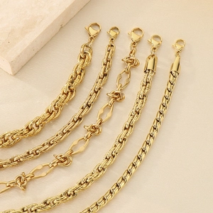 Macro detail of various gold-plated stainless steel chain link textures and lobster clasps