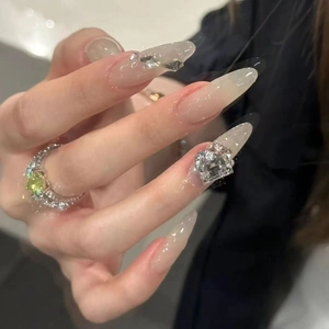 Translucent grey rhinestone press-on nails with a luxury pear-cut gemstone ring