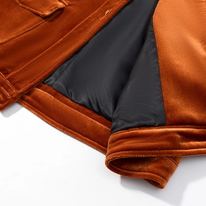 Detail of caramel velvet jacket hem showing soft fabric texture and black lining
