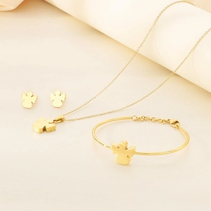 Detailed view of the gold jewelry set featuring angel pendant, cuff bracelet and stud earrings