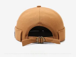 Detailed back view of caramel cotton brimless docker hat with adjustable metal buckle strap