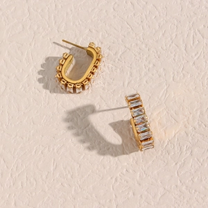 Close-up of gold geometric earrings with pavé set rectangular cubic zirconia stones
