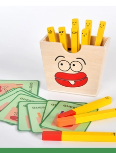 Detail of wooden french fries toy with cute emoji expressions and game cards