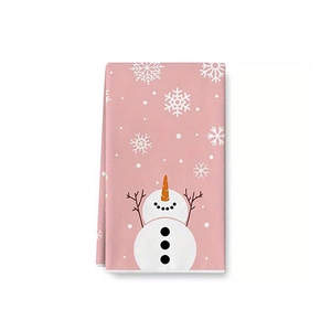 Detail of pink cotton kitchen towel with festive snowman and snowflake prints