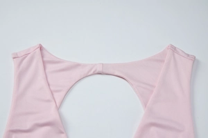 Detailed close-up of pink V-neck cutout and pleated stretch fabric on a summer dress