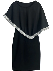 Detail of asymmetrical cape collar with shimmering silver sequins on black dress