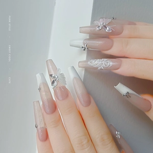 Pink gradient press-on nails with white French tips, 3D bows, pearls and silver chains