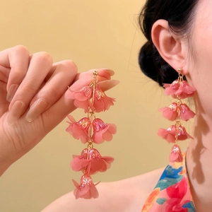 Detailed view of pink Lily of the Valley tassel earrings featuring delicate petals