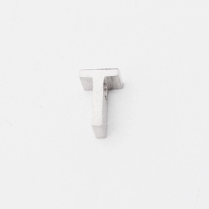 Macro view of a mirror-polished silver stainless steel letter T pendant bead
