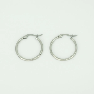 Close-up of classic polished silver stainless steel hoop earrings with snap closure