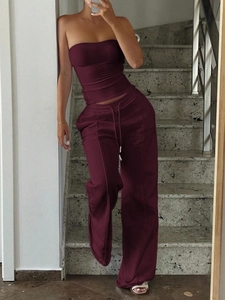 Deep red tube top and matching jogger pants set shown in a cozy indoor setting