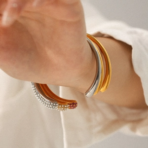 18k gold plated stainless steel bracelet set with pearls and purple diamonds on wrist