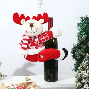 Detail of reindeer wine bottle cover with red antlers and knitted striped scarf
