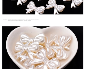 Detailed view of white pearl resin bow charms for DIY jewelry and clothing accessories