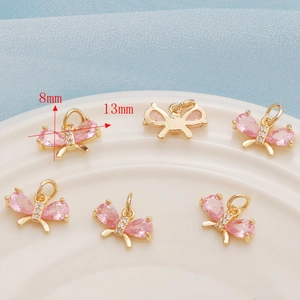 Detail of 14K gold butterfly pendants with pink zircon stones for DIY jewelry making