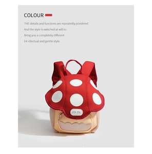 Detailed view of mushroom-shaped toddler backpack with red polka dots and front pocket