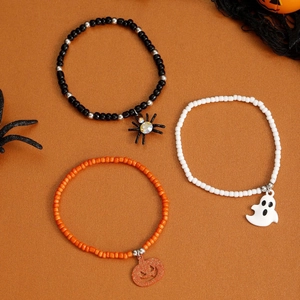 Halloween beaded bracelet set featuring spider ghost and pumpkin charms in black and orange