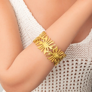 Macro shot of 18k gold plated cuff bracelet with organic leaf texture on model