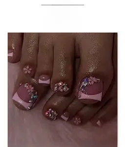 Detail of short square light pink press-on toenails with 3D floral and rhinestone accents