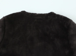 Detailed close-up of dark brown plush faux fur jacket neckline and soft texture