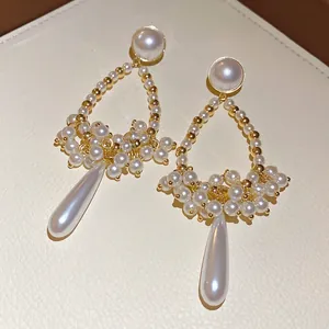 French vintage water drop pearl tassel earrings with gold-tone studs on leather