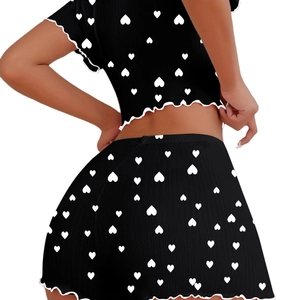 Women's black two-piece pajama set with white heart prints and lettuce trim back view