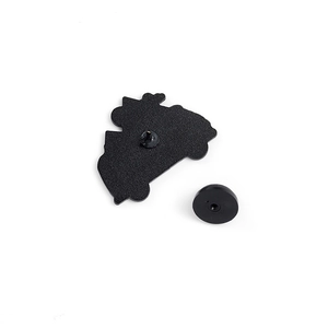 Detail of black enamel pin back with matte texture and a rubber clutch backing