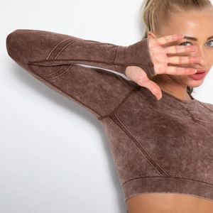 Close-up of coffee brown acid wash gym top featuring thumb holes and ribbed hem detail