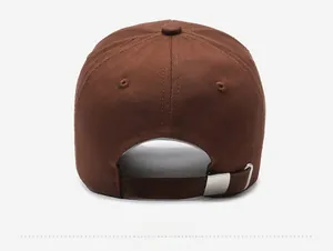 Detail of dark brown cotton baseball cap showing adjustable silver metal buckle and texture