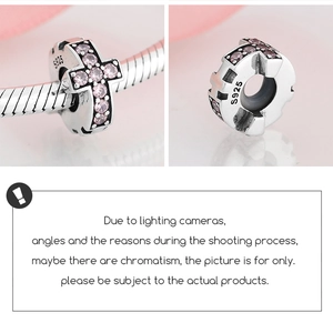 Macro view of S925 sterling silver spacer bead with pink gemstone cross pattern
