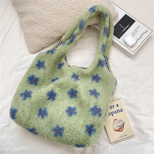 Detailed view of plush floral tote bag with soft faux fur texture and checkered lining