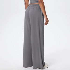 Detail view of high waist elastic waistband on dark grey wide-leg athletic pants