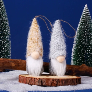 Detail of gold and silver Christmas gnomes on wood base with festive winter decor