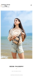 Outdoor close-up of straw crossbody bag with geometric strap against sea background
