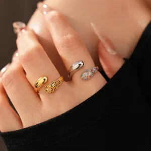 18k gold plated teardrop crossover ring with colorful zircon stones on black background