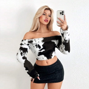 Close-up of cow print velvet off-shoulder cropped top with black lace skirt detail