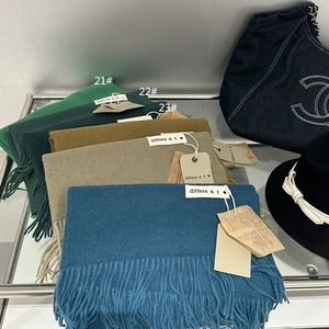 Close-up of winter solid color cashmere-feel scarves with tassels in various shades