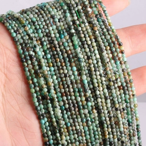 Macro shot of natural green turquoise round beads with brown textures on a hand