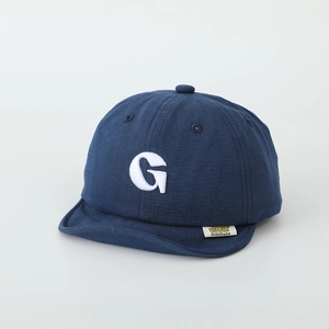 Detail of navy blue cotton baby cap with white embroidered G letter and soft brim texture