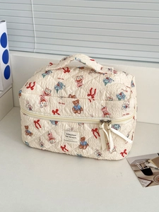 Quilted cream cosmetic bag with cute cartoon animal prints and dual zipper handle