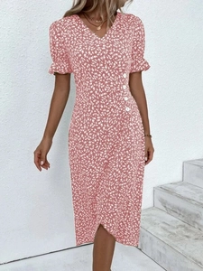 Detailed view of pink floral dress featuring puff sleeves and white button accents
