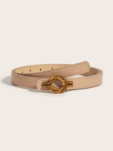 Detail of beige skinny faux leather belt with a golden knot-textured metal buckle