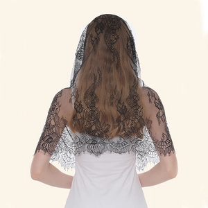 Detail of black lace veil featuring intricate floral patterns and scalloped edges for women