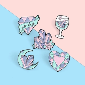 Set of five pastel enamel pins featuring moon, heart, and crystal cluster designs