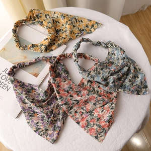 Detailed flat lay of three floral chiffon headbands in yellow, purple and pink colors